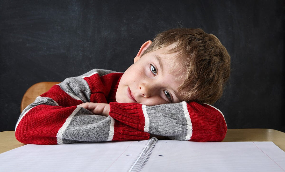 Boy head down on desk and checked out