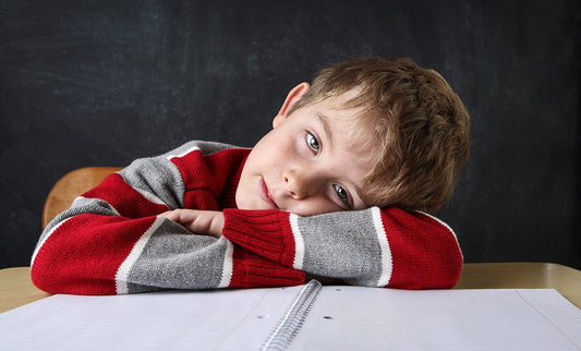 Boy head down on desk and checked out
