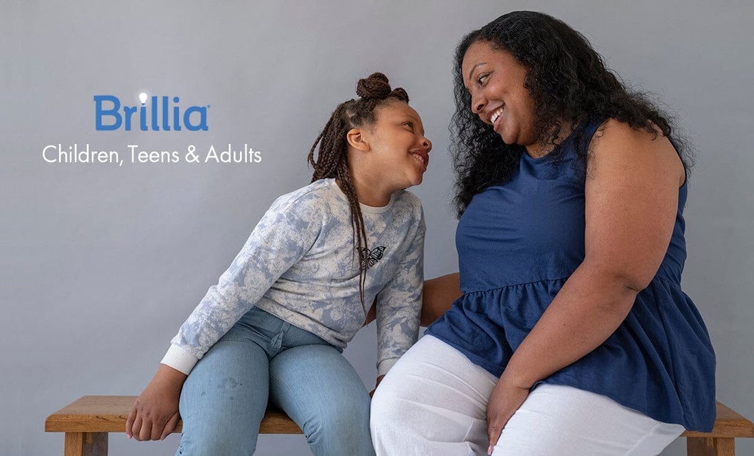 Black mother and young daughter smiling at each other