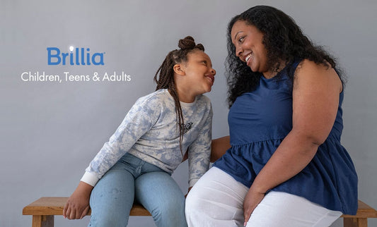 Black mother and young daughter smiling at each other
