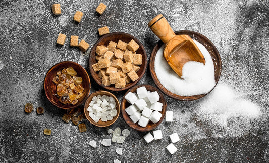 Different types of sugar on gray background