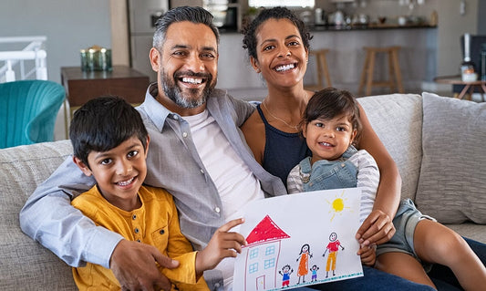 Family of four on sofa with child drawing
