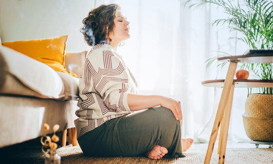 Woman in living room practicing mindfulness