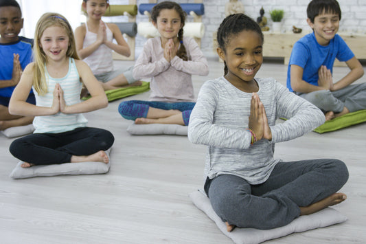 Happy children meditating.