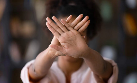 Woman crossed hands in front of face