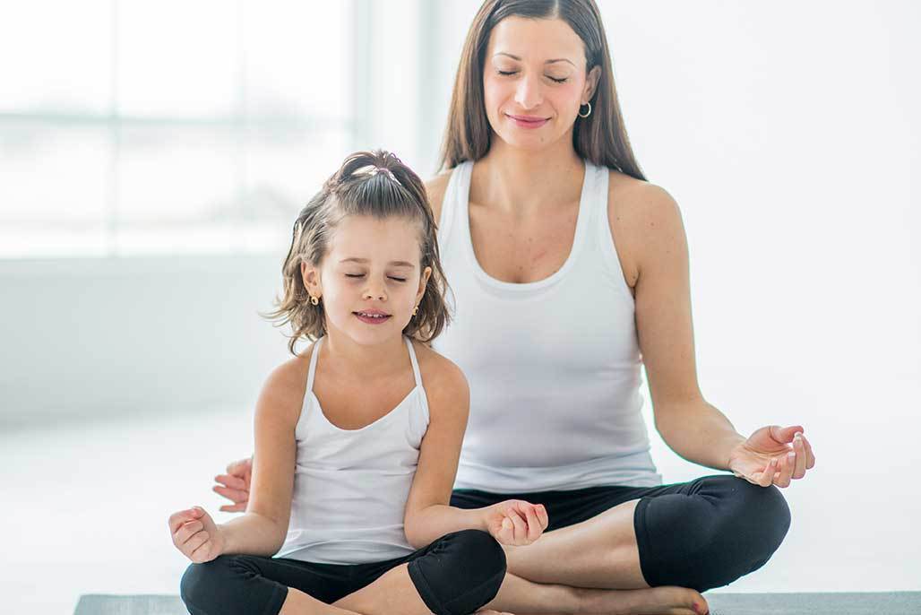 Mother and Daughter Doing Calming Exercises for Kids