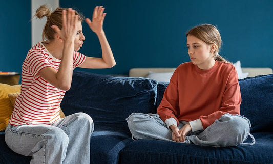 Mom on sofa upset with irritable daughter