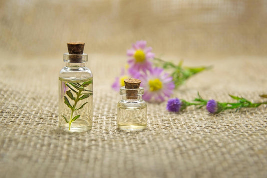 Oils in bottles surrounded by flowers