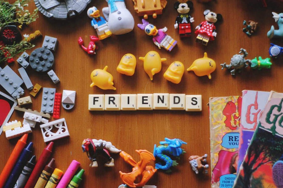Scrabble letters spelling the word "friend" while surrounded by toys